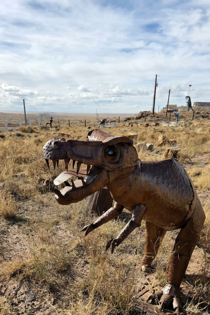 Metal T-Rex sculpture in the desert